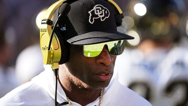 Deion Sanders walks the sidelines as the Colorado plays Arizona State at Mountain America Stadium.