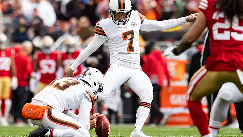 Oct 15, 2023; Cleveland, Ohio, USA; Cleveland Browns punter Corey Bojorquez (13) holds the ball for place kicker Dustin Hopkins (7) as he kicks a point after against the San Francisco 49ers during the second quarter try at Cleveland Browns Stadium. Mandatory Credit: Scott Galvin-USA TODAY Sports