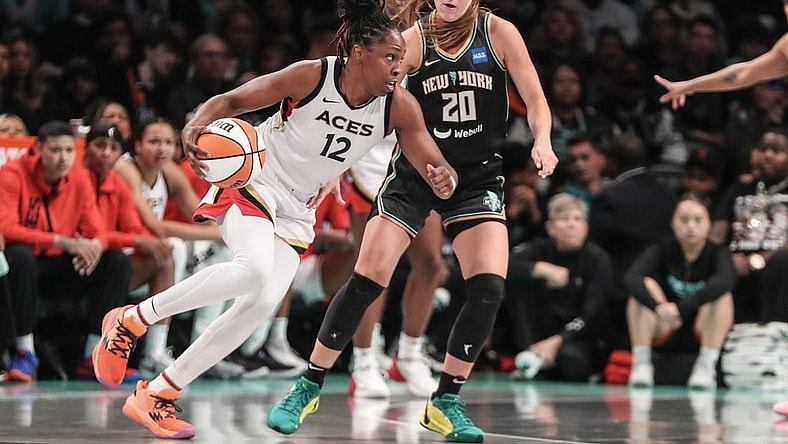 Oct 15, 2023; Brooklyn, New York, USA; Las Vegas Aces guard Chelsea Gray (12) drives around New York Liberty guard Sabrina Ionescu (20) in the third quarter during game three of the 2023 WNBA Finals at Barclays Center. Mandatory Credit: Wendell Cruz-USA TODAY Sports