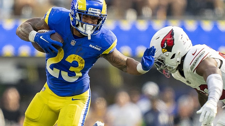 October 15, 2023; Inglewood, California, USA; Los Angeles Rams running back Kyren Williams (23) runs the football against Arizona Cardinals cornerback Marco Wilson (20) during the third quarter at SoFi Stadium. Mandatory Credit: Kyle Terada-USA TODAY Sports