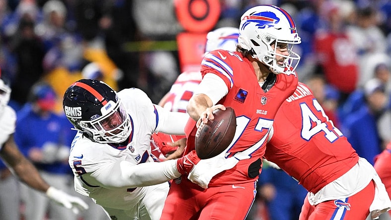 Oct 15, 2023; Orchard Park, New York, USA; Buffalo Bills quarterback Josh Allen (17) tries to avoid a tackle by New York Giants linebacker Kayvon Thibodeaux (5) in the third quarter at Highmark Stadium. Mandatory Credit: Mark Konezny-USA TODAY Sports