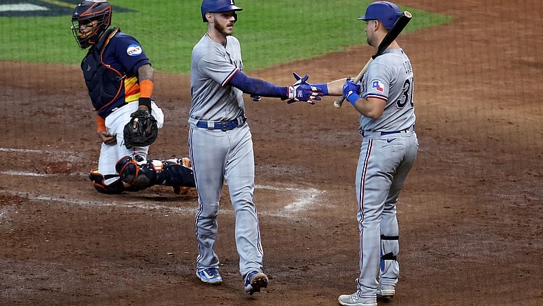 Oct 16, 2023; Houston, Texas, USA; Texas Rangers catcher Jonah Heim (28) celebrates with first baseman Nathaniel Lowe (30) after hitting a home run in the third inning against the Houston Astros during game two of the ALCS for the 2023 MLB playoffs at Minute Maid Park. Mandatory Credit: Troy Taormina-USA TODAY Sports
