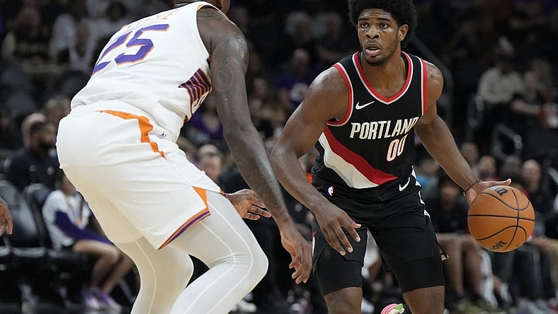 Oct 16, 2023; Phoenix, Arizona, USA; Portland Trail Blazers guard Scoot Henderson (00) drives past Phoenix Suns guard Nassir Little (25) in the second half at Footprint Center. Mandatory Credit: Rick Scuteri-USA TODAY Sports
