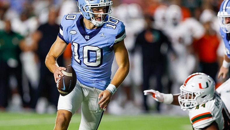 Oct 14, 2023; Chapel Hill, North Carolina, USA; North Carolina Tar Heels quarterback Drake Maye (10) runs against the Miami Hurricanes in the first half at Kenan Memorial Stadium. Mandatory Credit: Nell Redmond-USA TODAY Sports