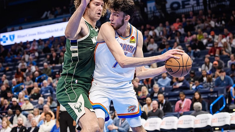Oct 17, 2023; Oklahoma City, Oklahoma, USA; Oklahoma City Thunder forward Chet Holmgren (7) fights for position while defended by Milwaukee Bucks center Robin Lopez (42) during the first half at Paycom Center. Mandatory Credit: Rob Ferguson-USA TODAY Sports
