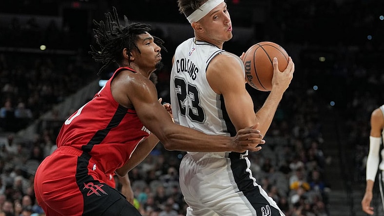 Oct 18, 2023; San Antonio, Texas, USA; San Antonio Spurs forward Zach Collins (23) spins around Houston Rockets forward Jermaine Samuels (00) in the first half at the Frost Bank Center. Mandatory Credit: Daniel Dunn-USA TODAY Sports