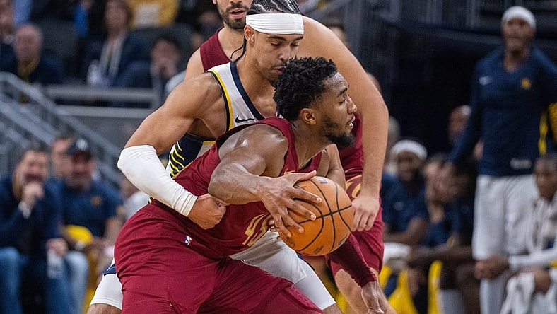 Oct 20, 2023; Indianapolis, Indiana, USA; Cleveland Cavaliers guard Donovan Mitchell (45) dribbles the ball while Indiana Pacers guard Andrew Nembhard (2) defends  in the second half at Gainbridge Fieldhouse. Mandatory Credit: Trevor Ruszkowski-USA TODAY Sports