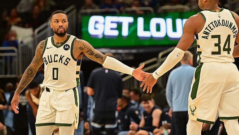 Oct 20, 2023; Milwaukee, Wisconsin, USA; Milwaukee Bucks guard Damian Lillard (0) greets forward Giannis Antetokounmpo (34) during game against the Memphis Grizzlies at Fiserv Forum. Mandatory Credit: Benny Sieu-USA TODAY Sports