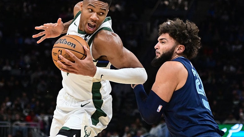 Oct 20, 2023; Milwaukee, Wisconsin, USA; Milwaukee Bucks forward Giannis Antetokounmpo (34) drives for the basket against Memphis Grizzlies center David Roddy (21) in the third quarter at Fiserv Forum. Mandatory Credit: Benny Sieu-USA TODAY Sports