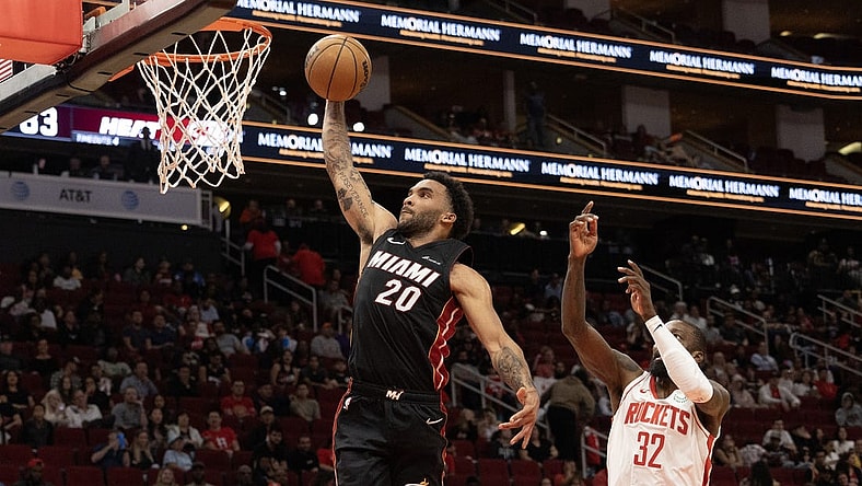 Oct 20, 2023; Houston, Texas, USA; Miami Heat forward Justin Champagnie (20) dunks as Houston Rockets forward Jeff Green (32) defends in the fourth quarter at Toyota Center. Mandatory Credit: Thomas Shea-USA TODAY Sports