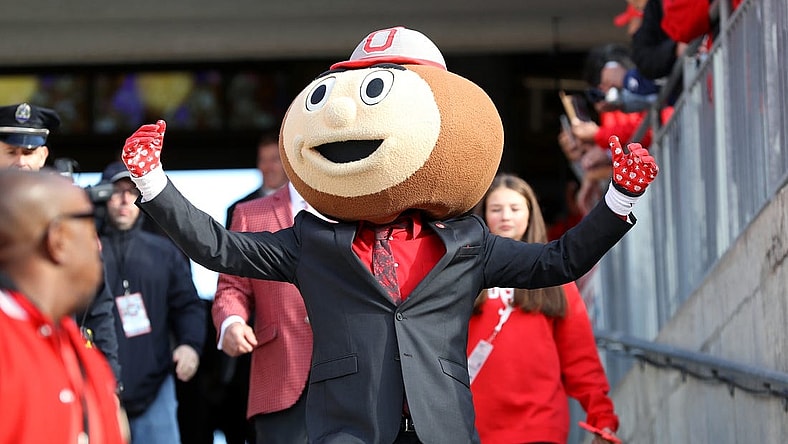 Oct 21, 2023; Columbus, Ohio, USA;  Ohio State Buckeyes mascot Brutus Buckeye greets fans before a game against the Penn State Nittany Lions at Ohio Stadium. Mandatory Credit: Joseph Maiorana-USA TODAY Sports