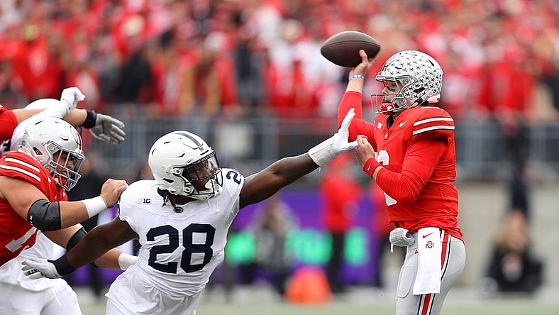Oct 21, 2023; Columbus, Ohio, USA; Ohio State Buckeyes quarterback Kyle McCord (6) is hit as he throws by Penn State Nittany Lions defensive tackle Zane Durant (28) during the second quarter at Ohio Stadium. Mandatory Credit: Joseph Maiorana-USA TODAY Sports