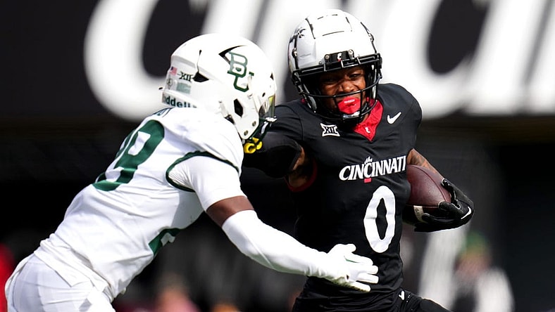 Cincinnati Bearcats wide receiver Braden Smith (0) stiff arms Baylor Bears safety Romario Noel (29) on a carry in the first quarter during a college football game between the Baylor Bears and the Cincinnati Bearcats, Saturday, Oct. 21, 2023, at Nippert Stadium in Cincinnati.