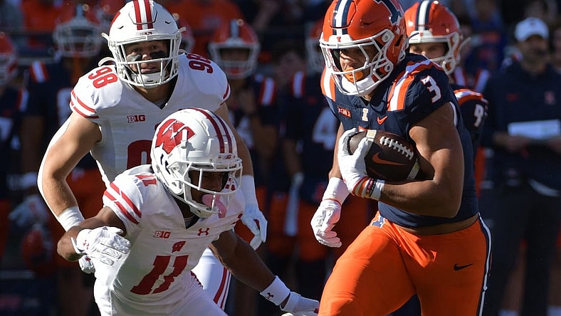 Oct 21, 2023; Champaign, Illinois, USA;  Illinois Fighting Illini running back Kaden Feagin (3) runs the ball against Wisconsin Badgers cornerback Alexander Smith (11) during the first half at Memorial Stadium. Mandatory Credit: Ron Johnson-USA TODAY Sports