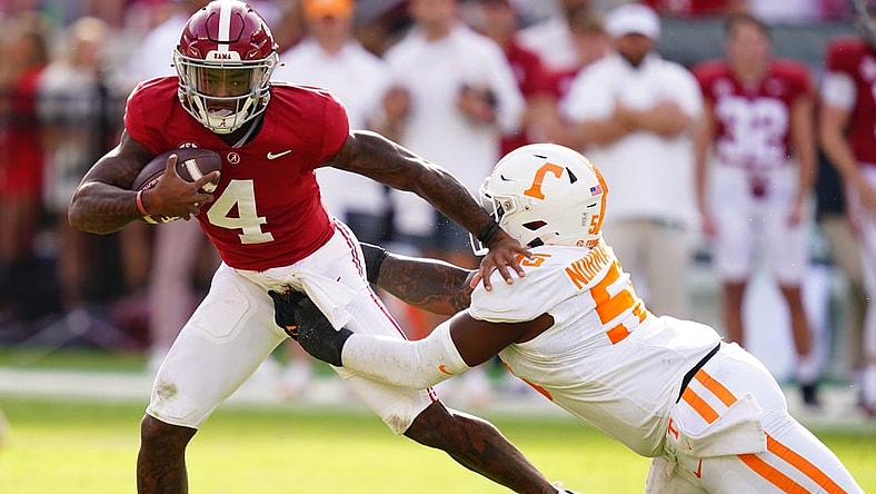 Oct 21, 2023; Tuscaloosa, Alabama, USA; Alabama Crimson Tide quarterback Jalen Milroe (4) gets sacked behind the line of scrimmage by Tennessee Volunteers defensive lineman Omarr Norman-Lott (55) during the first half at Bryant-Denny Stadium. Mandatory Credit: John David Mercer-USA TODAY Sports