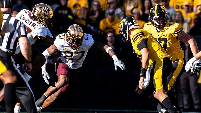 Minnesota defensive back Tyler Nubin (27) jumps on a fumble by Iowa quarterback Deacon Hill (10) at Kinnick Stadium on Saturday, October 21, 2023 in Iowa City.