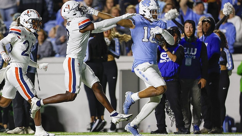 Oct 21, 2023; Chapel Hill, North Carolina, USA; North Carolina Tar Heels tight end Bryson Nesbit (18) scores a touchdown after a catch against Virginia Cavaliers safety Coen King (9) in the first half at Kenan Memorial Stadium. Mandatory Credit: Nell Redmond-USA TODAY Sports