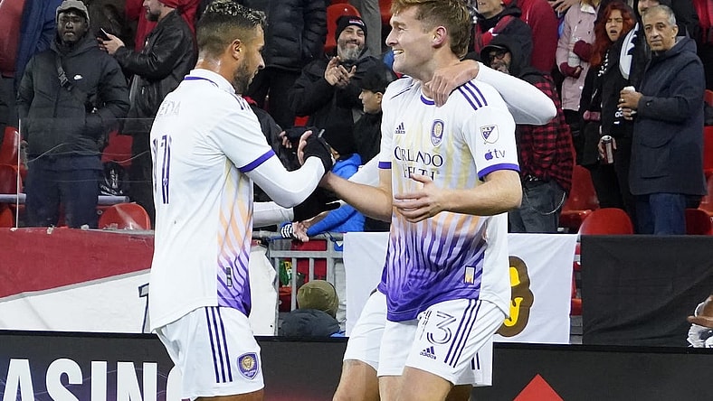 Oct 21, 2023; Toronto, Ontario, CAN; Orlando City SC midfielder Martin Ojeda (11) congratulates forward Duncan McGuire (13) on the first of his two goals against Toronto FC  during the second half at BMO Field. Mandatory Credit: John E. Sokolowski-USA TODAY Sports