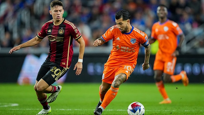 Oct 21, 2023; Cincinnati, Ohio, USA; FC Cincinnati midfielder Luciano Acosta (10) dribbles the ball against Atlanta United FC midfielder Matheus Rossetto (20) in the second half at TQL Stadium. Mandatory Credit: Aaron Doster-USA TODAY Sports