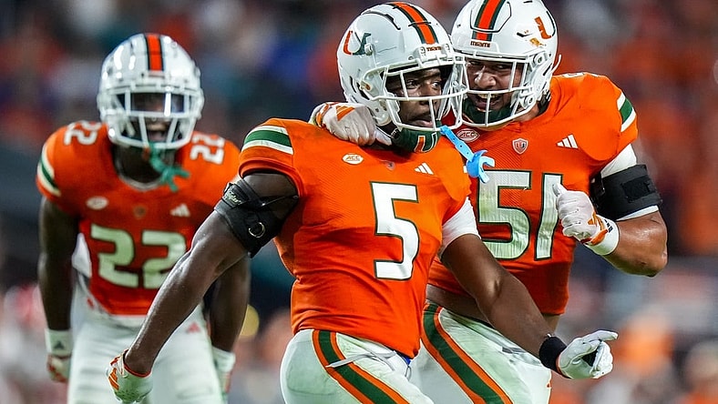 Oct 21, 2023; Miami Gardens, Florida, USA; Miami Hurricanes safety Kamren Kinchens (5) celebrates with teammates after catching a interception against the Clemson Tigers during the second quarter at Hard Rock Stadium. Mandatory Credit: Rich Storry-USA TODAY Sports