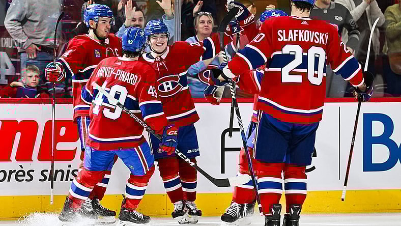 Oct 21, 2023; Montreal, Quebec, CAN; Montreal Canadiens right wing Cole Caufield (22) celebrates his winning goal against the Washington Capitals with his teammates during overtime at Bell Centre. Mandatory Credit: David Kirouac-USA TODAY Sports
