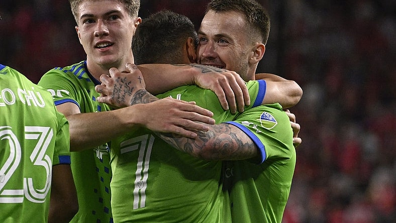 Oct 21, 2023; St. Louis, Missouri, USA; Seattle Sounders midfielder Cristian Roldan (7) congratulates Seattle Sounders midfielder Albert Rusnak (11) after Rusnak scored a goal against St. Louis City in the first half at CITYPARK. Mandatory Credit: Joe Puetz-USA TODAY Sports