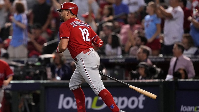 Oct 21, 2023; Phoenix, Arizona, USA; Philadelphia Phillies left fielder Kyle Schwarber (12) hits a home run against the Arizona Diamondbacks in the sixth inning during game five of the NLCS for the 2023 MLB playoffs at Chase Field. Mandatory Credit: Joe Camporeale-USA TODAY Sports