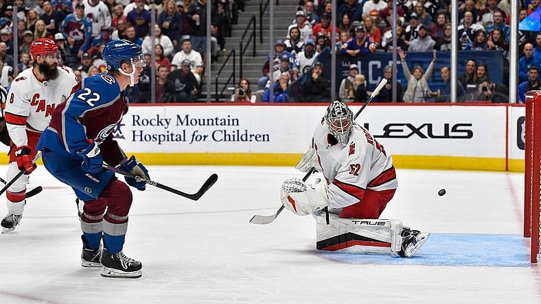 Oct 21, 2023; Denver, Colorado, USA; Colorado Avalanche center Fredrik Olofsson (22) takes a shot on Carolina Hurricanes goaltender Pyotr Kochetkov (52) for a goal in the second period at Ball Arena. Mandatory Credit: John Leyba-USA TODAY Sports