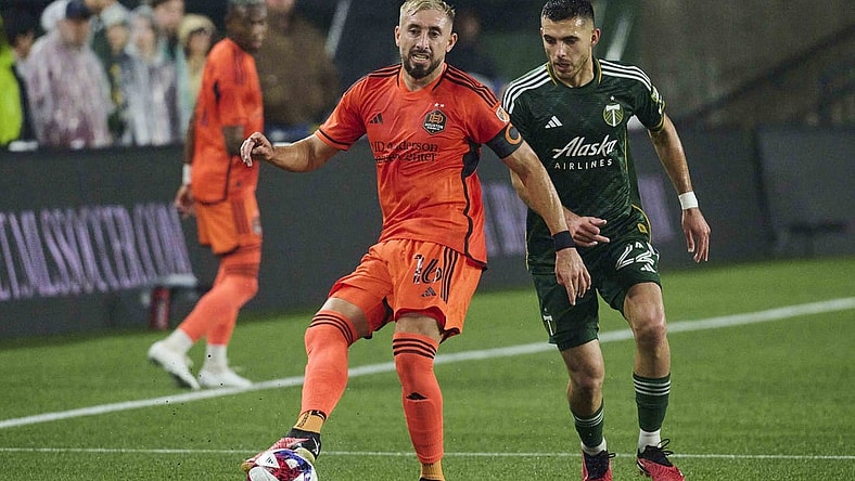 Oct 21, 2023; Portland, Oregon, USA; Houston Dynamo midfielder Hector Herrera (16) passes the ball against Portland Timbers midfielder Cristhian Paredes (22) during the first half at Providence Park. Mandatory Credit: Troy Wayrynen-USA TODAY Sports