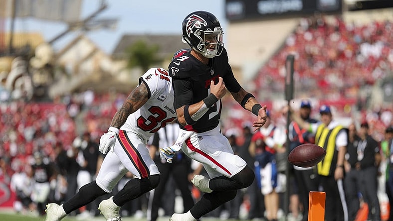 Oct 22, 2023; Tampa, Florida, USA;  Tampa Bay Buccaneers safety Antoine Winfield Jr. (31) forces a fumble by Atlanta Falcons quarterback Desmond Ridder (9) at the goal line in the fourth quarter at Raymond James Stadium. Mandatory Credit: Nathan Ray Seebeck-USA TODAY Sports