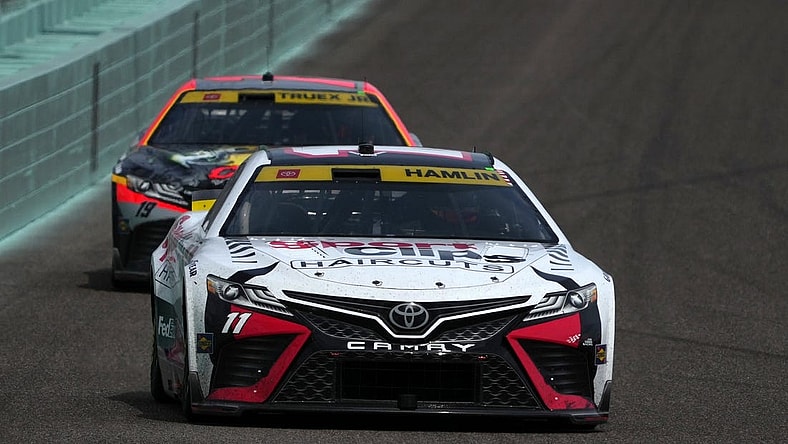 Oct 22, 2023; Homestead, Florida, USA; NASCAR Cup Series driver Denny Hamlin (11) leads NASCAR Cup Series driver Martin Truex Jr (19) during the 4EVER 400 presented by Mobil 1 at Homestead-Miami Speedway. Mandatory Credit: Jasen Vinlove-USA TODAY Sports