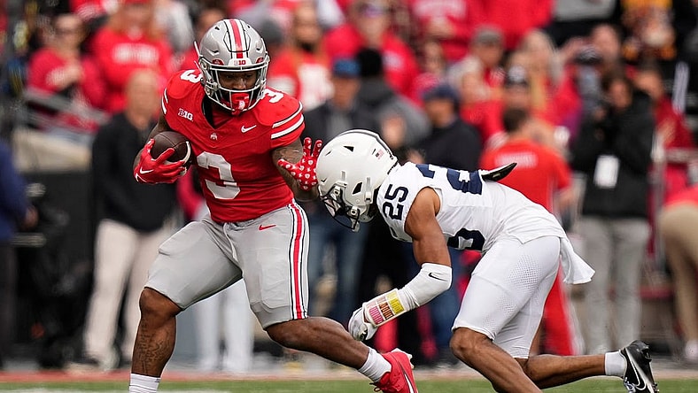Oct 21, 2023; Columbus, Ohio, USA; Ohio State Buckeyes running back Miyan Williams (3) runs past Penn State Nittany Lions running back DK Kency (25) during the NCAA football game at Ohio Stadium.