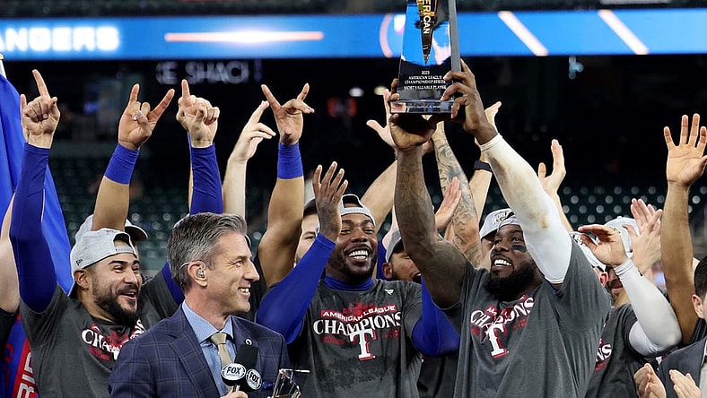 Oct 23, 2023; Houston, Texas, USA; Texas Rangers right fielder Adolis Garcia (53) holds the American League championship series MVP trophy after winning game seven in the ALCS against the Houston Astros for the 2023 MLB playoffs at Minute Maid Park. Mandatory Credit: Thomas Shea-USA TODAY Sports