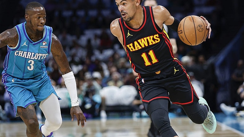 Oct 25, 2023; Charlotte, North Carolina, USA;  Atlanta Hawks guard Trae Young (11) drives around Charlotte Hornets guard Terry Rozier (3) during the first quarter at Spectrum Center. Mandatory Credit: Nell Redmond-USA TODAY Sports