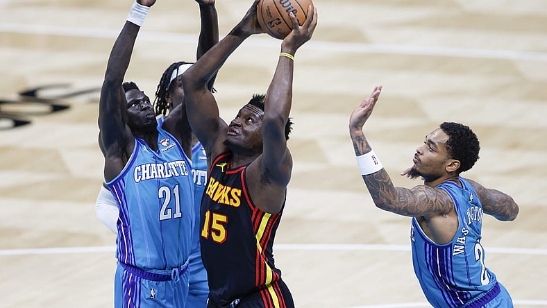 Oct 25, 2023; Charlotte, North Carolina, USA; Atlanta Hawks center Clint Capela (15) drives to the basket between Charlotte Hornets forwards JT Thor and  P.J. Washington (25) during the second quarter at Spectrum Center. Mandatory Credit: Nell Redmond-USA TODAY Sports