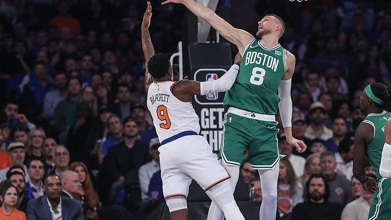 Oct 25, 2023; New York, New York, USA; Boston Celtics center Kristaps Porzingis (8) blocks a shot taken by New York Knicks guard RJ Barrett (9) in the first quarter at Madison Square Garden. Mandatory Credit: Wendell Cruz-USA TODAY Sports
