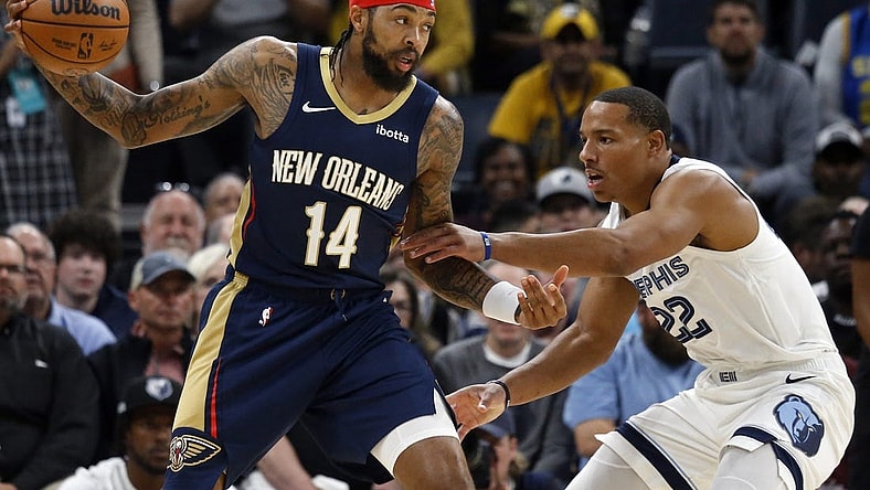 Oct 25, 2023; Memphis, Tennessee, USA; New Orleans Pelicans forward Brandon Ingram (14) catches a pass as Memphis Grizzlies guard Desmond Bane (22) defends during the first half at FedExForum. Mandatory Credit: Petre Thomas-USA TODAY Sports