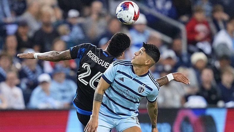 Oct 25, 2023; Kansas City, KS, USA; Sporting Kansas City forward Alan Pulido (9) battles San Jose Earthquakes defender Rodrigues (26) for the ball in the second half in the Western Conference Wild Card match of the 2023 MLS Cup Playoffs at Children's Mercy Park. Mandatory Credit: Jay Biggerstaff JB-USA TODAY Sports