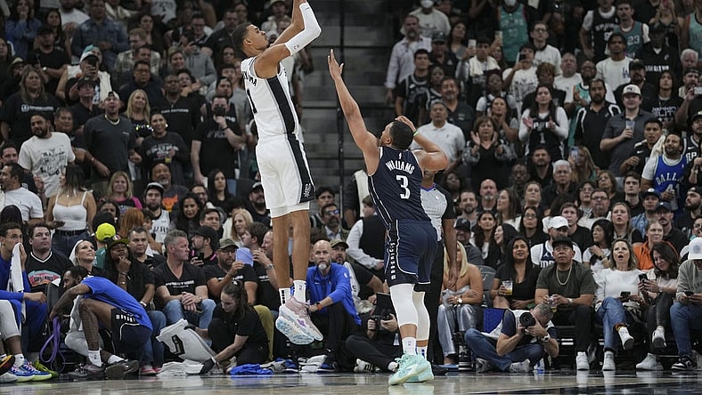 Oct 25, 2023; San Antonio, Texas, USA;  San Antonio Spurs center Victor Wembanyama (1) shoots over Dallas Mavericks forward Grant Williams (3) in the second half at the Frost Bank Center. Mandatory Credit: Daniel Dunn-USA TODAY Sports