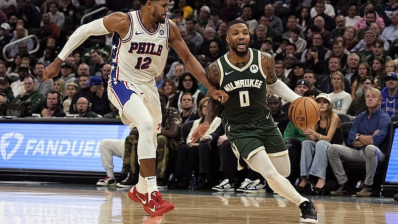 Oct 26, 2023; Milwaukee, Wisconsin, USA;  Milwaukee Bucks guard Damian Lillard (0) drives for the basket around Philadelphia 76ers forward Tobias Harris (12) during the second quarter at Fiserv Forum. Mandatory Credit: Jeff Hanisch-USA TODAY Sports
