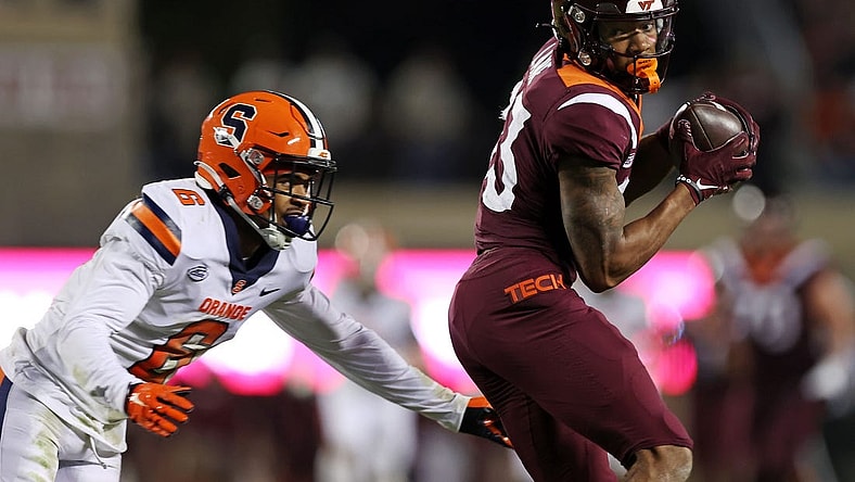 Oct 26, 2023; Blacksburg, Virginia, USA; Virginia Tech Hokies wide receiver Jaylin Lane (83) catches a pass against Syracuse Orange defensive back Jason Simmons Jr. (6) during the second quarter at Lane Stadium. Mandatory Credit: Peter Casey-USA TODAY Sports