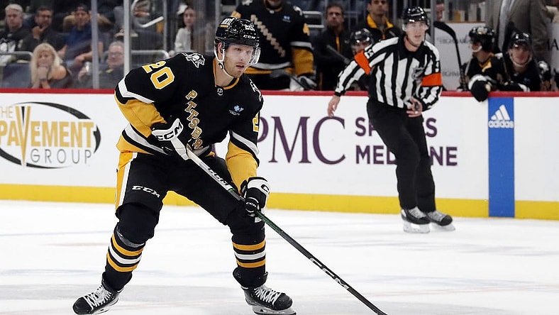Oct 26, 2023; Pittsburgh, Pennsylvania, USA; Pittsburgh Penguins center Lars Eller (20) skates the puck up ice against the Colorado Avalanche during the third period at PPG Paints Arena. The Penguins shutout the Avalanche 4-0. Mandatory Credit: Charles LeClaire-USA TODAY Sports