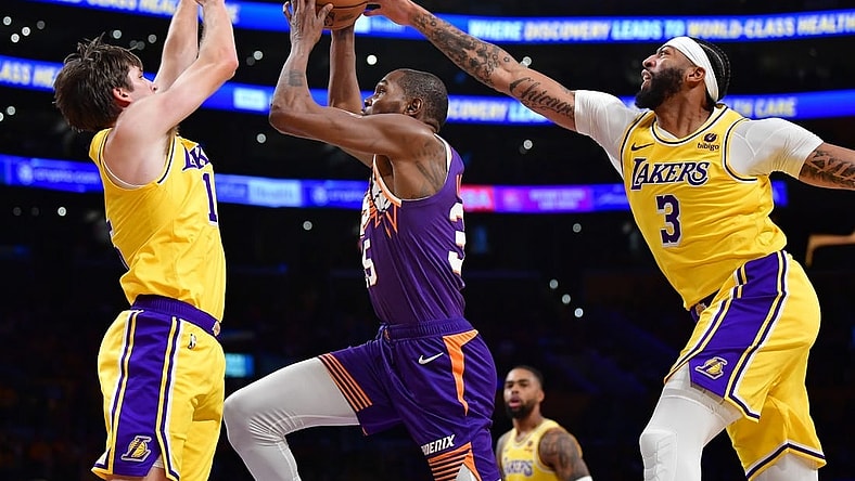 Oct 26, 2023; Los Angeles, California, USA; Phoenix Suns forward Kevin Durant (35) moves to the basket against Los Angeles Lakers guard Austin Reaves (15) and forward Anthony Davis (3) during the first half at Crypto.com Arena. Mandatory Credit: Gary A. Vasquez-USA TODAY Sports