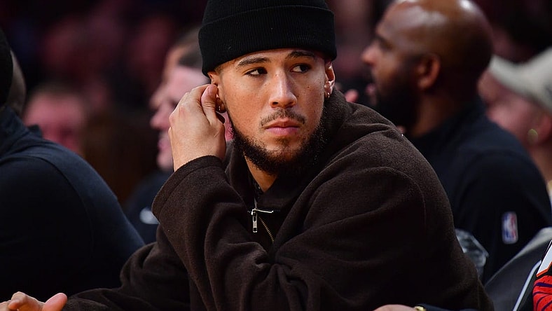 Oct 26, 2023; Los Angeles, California, USA; Phoenix Suns guard Devin Booker (1) watches game action against the Los Angeles Lakers during the first half at Crypto.com Arena. Mandatory Credit: Gary A. Vasquez-USA TODAY Sports