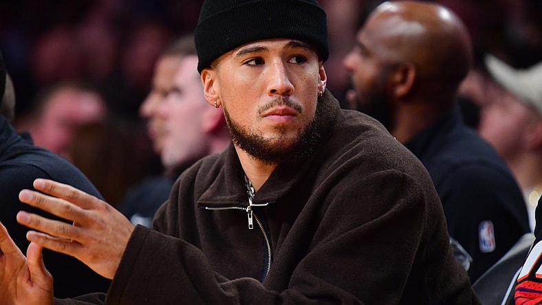 Oct 26, 2023; Los Angeles, California, USA; Phoenix Suns guard Devin Booker (1) watches game action against the Los Angeles Lakers during the first half at Crypto.com Arena. Mandatory Credit: Gary A. Vasquez-USA TODAY Sports