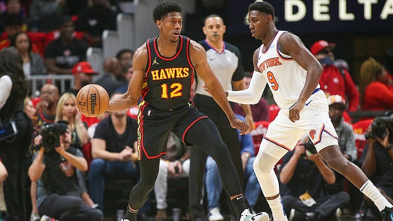 Oct 27, 2023; Atlanta, Georgia, USA; Atlanta Hawks forward De'Andre Hunter (12) is defended by New York Knicks guard RJ Barrett (9) in the first quarter at State Farm Arena. Mandatory Credit: Brett Davis-USA TODAY Sports