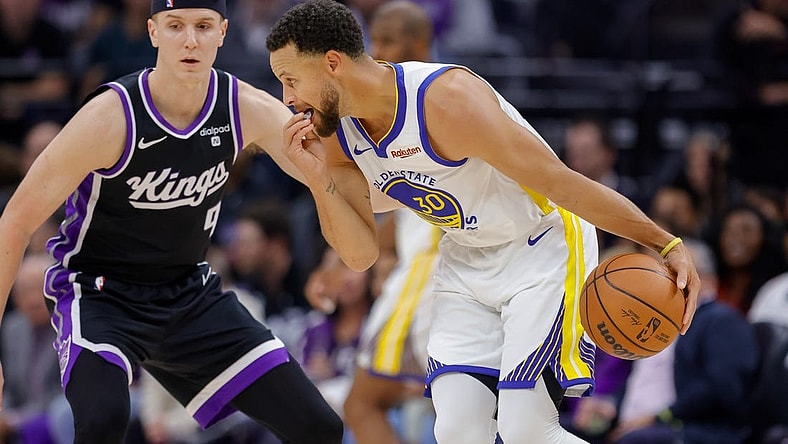 Oct 27, 2023; Sacramento, California, USA; Golden State Warriors guard Stephen Curry (30) dribbles the ball against Sacramento Kings guard Kevin Huerter (9) during the first quarter at Golden 1 Center. Mandatory Credit: Sergio Estrada-USA TODAY Sports