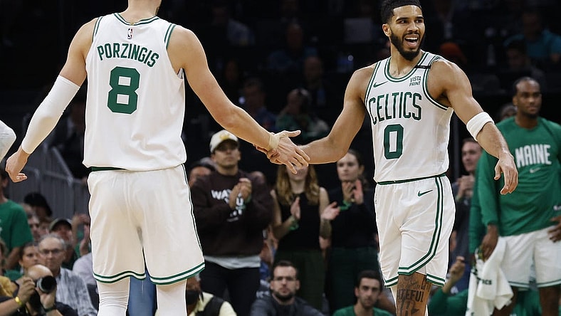 Oct 27, 2023; Boston, Massachusetts, USA; Boston Celtics forward Jayson Tatum (0) slaps hands with center Kristaps Porzingis (8) during the second quarter against the Miami Heat at TD Garden. Mandatory Credit: Winslow Townson-USA TODAY Sports