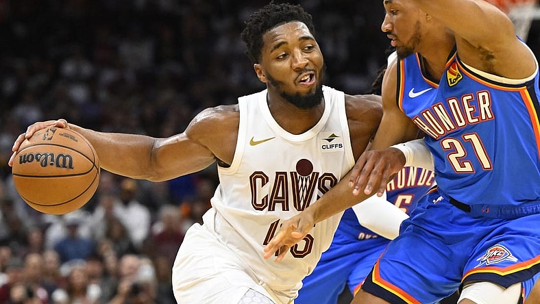 Oct 27, 2023; Cleveland, Ohio, USA; Cleveland Cavaliers guard Donovan Mitchell (45) drives against Oklahoma City Thunder guard Aaron Wiggins (21) in the fourth quarter at Rocket Mortgage FieldHouse. Mandatory Credit: David Richard-USA TODAY Sports