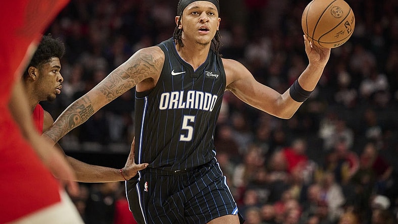 Oct 27, 2023; Portland, Oregon, USA; Orlando Magic forward Paolo Banchero (5) passes the ball during the second half against Portland Trail Blazers guard Scoot Henderson (00) at Moda Center. Mandatory Credit: Troy Wayrynen-USA TODAY Sports